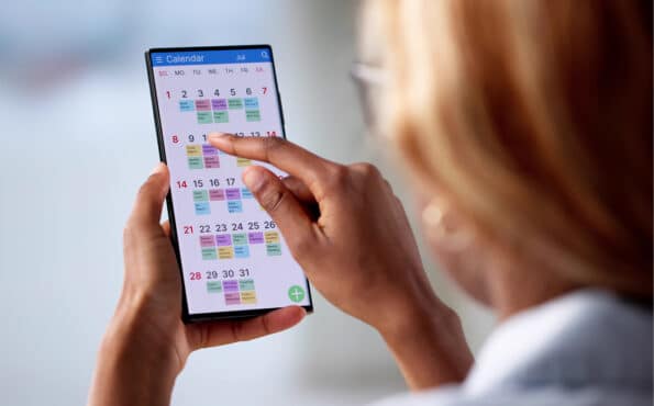 Close-up of a female pet business owner managing her appointments on her smartphone