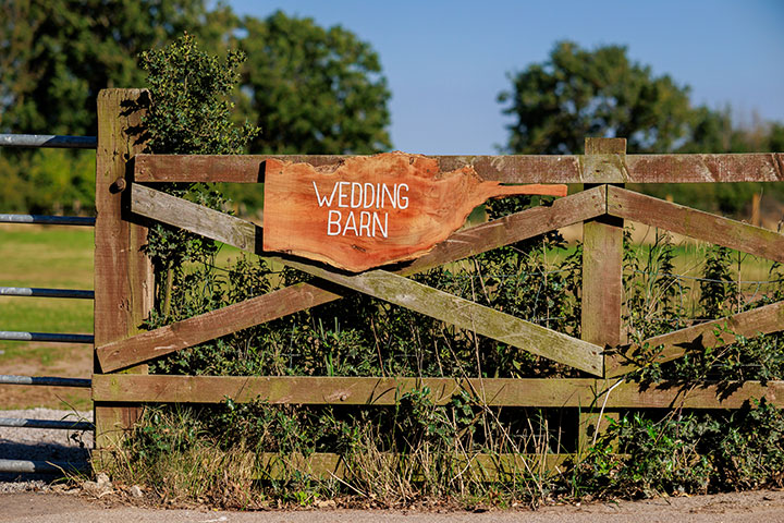  ‘Wedding barn’ sign at the entrance of a small holding farm venue in the UK sunshine 